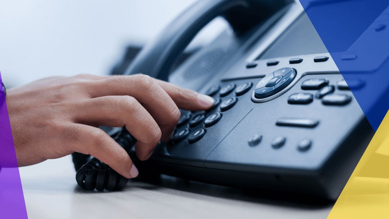 close up employee man hand point to press button number on telephone office desk for contact customer or colleagues in company